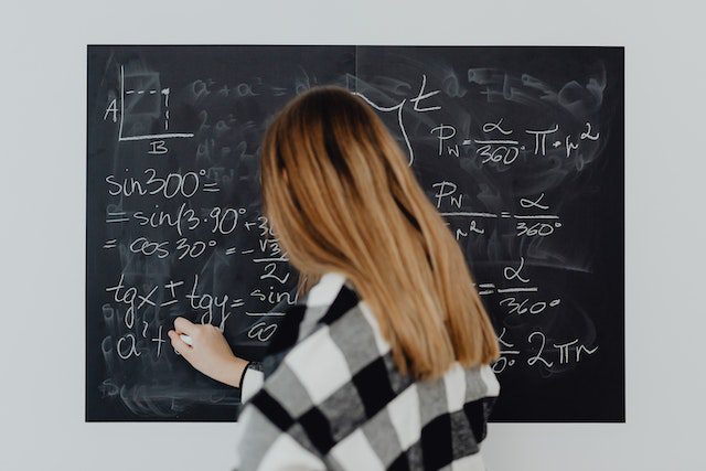 Pexels- Women Writing on Board