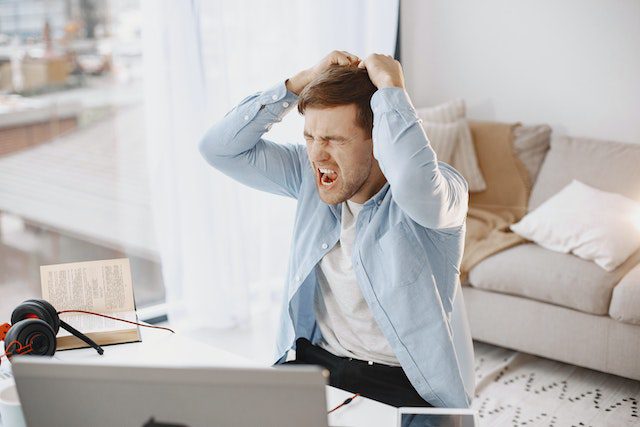 Upset Man Shouting at Desk