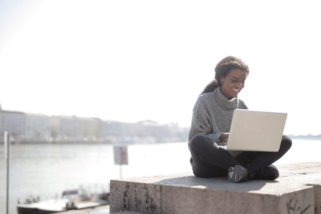 Woman using laptop writing a strong letter of recommendation in 2024