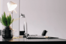 Grey Laptop on Black Wooden Desk