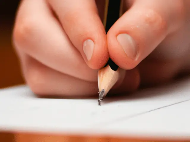 writing an essay on paper with a pencil