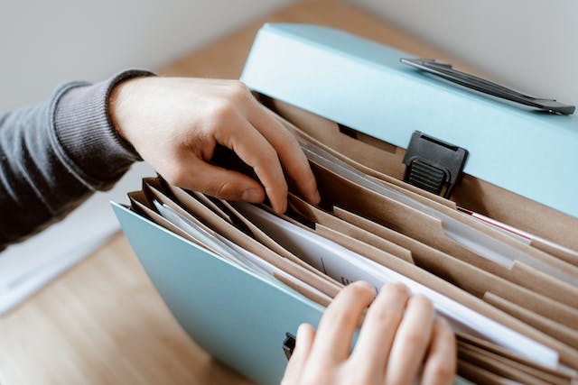 person choosing document in folder