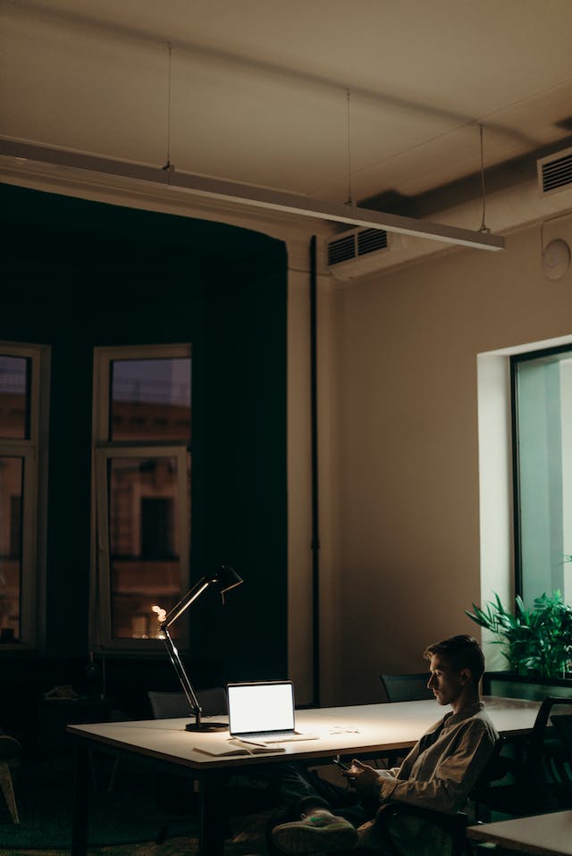 man in black jacket sitting on chair