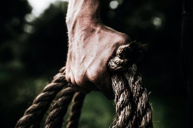 man holding brown rope
