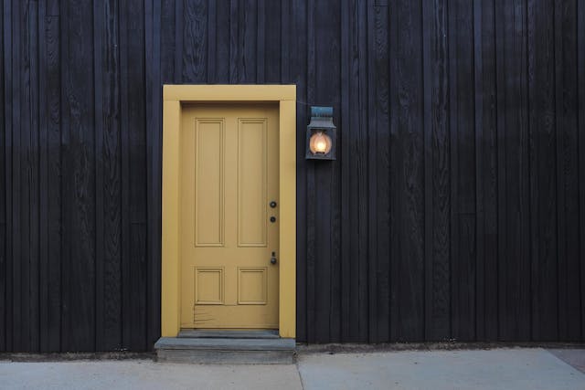 closed door and lighted light sconce