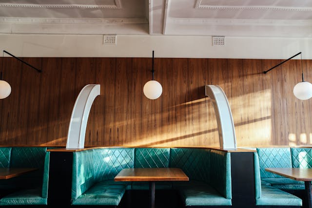 interior of modern restaurant with leather seats and wooden tables