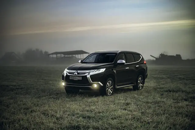 photo of montero sport parked on grass field