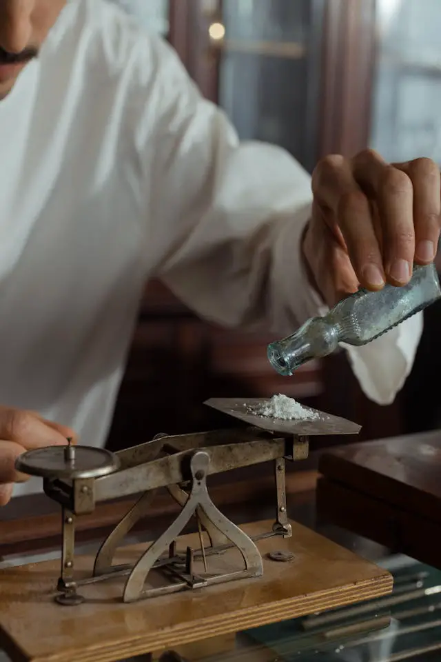 a man holding weighing white powder