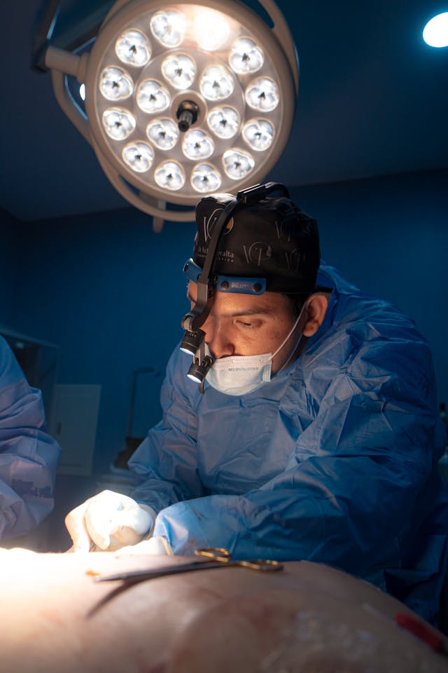 surgeon performing medical procedure under bright lights
