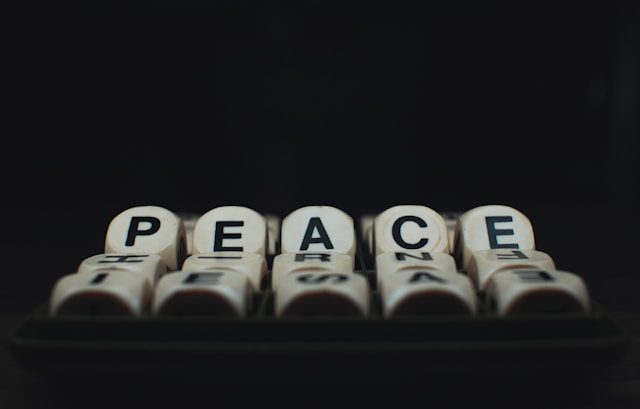 a group of dices with the words peace written on them