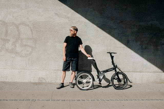 a man standing next to a bicycle