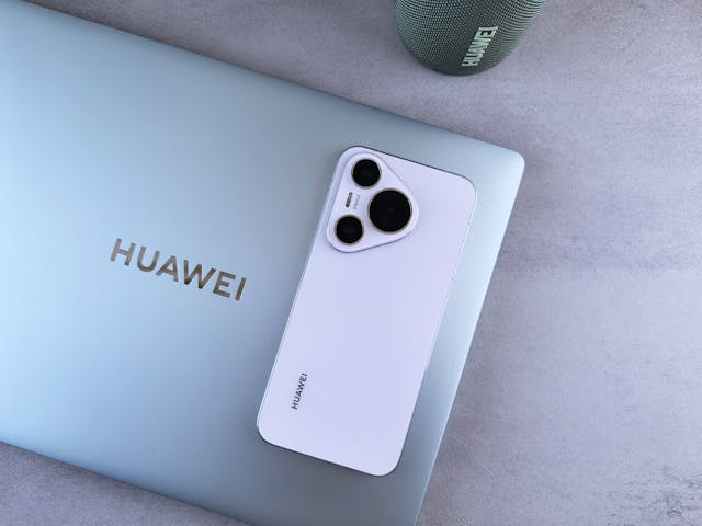 a white phone next to a laptop