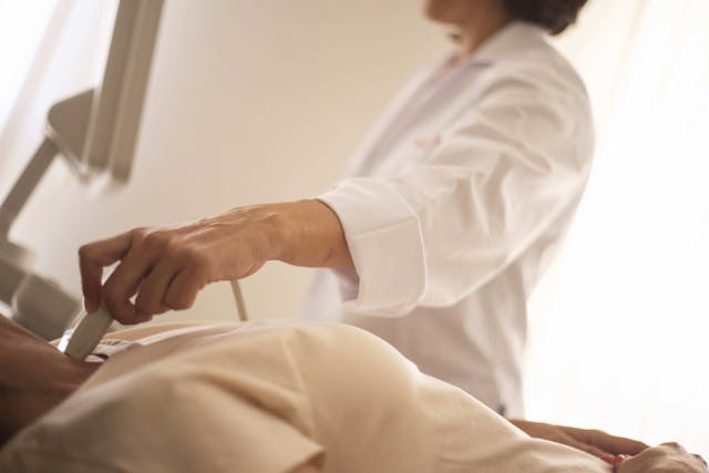 doctor over patient lying down