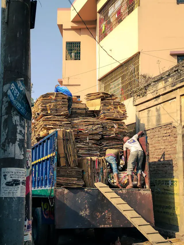 workers loading recycled cardboard onto truck