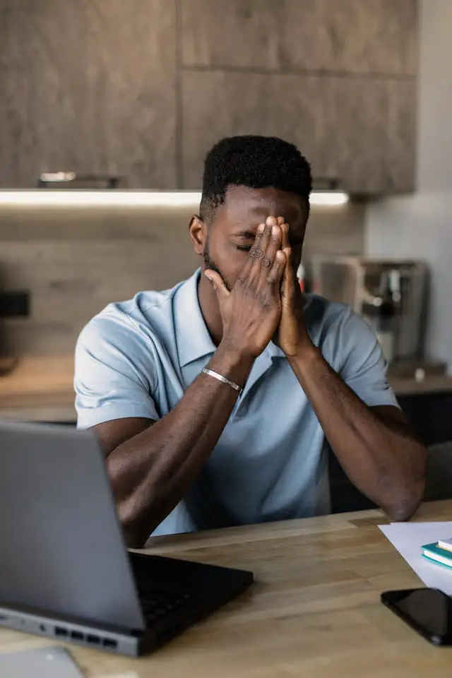 a man in white polo shirt looking frustrated