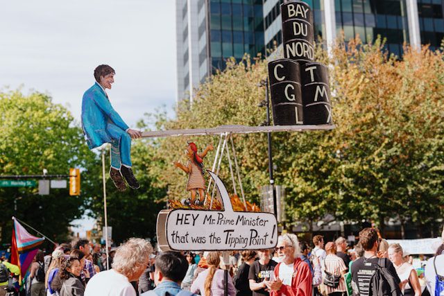 a man is sitting on top of a sign