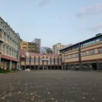 an empty parking lot in front of a row of buildings