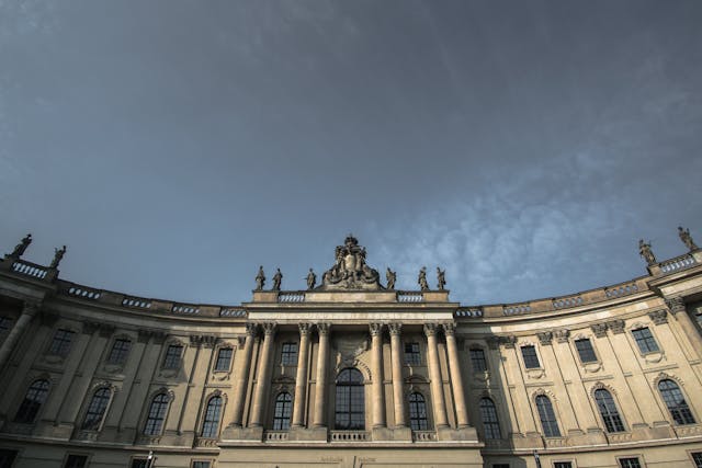 white and gray concrete building under gray daytime sky