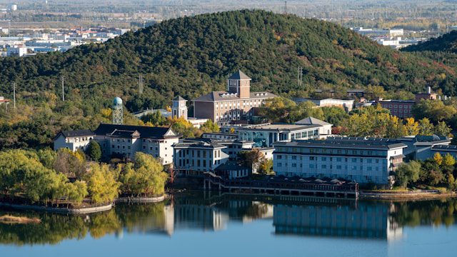 a body of water with buildings and trees around it