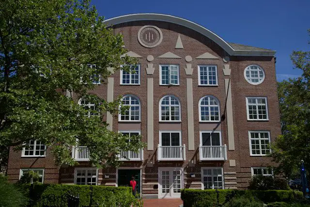 a brick building with a person standing in front of it