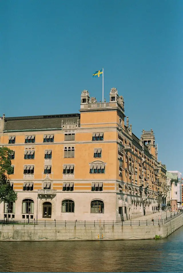 a large building sitting next to a body of water