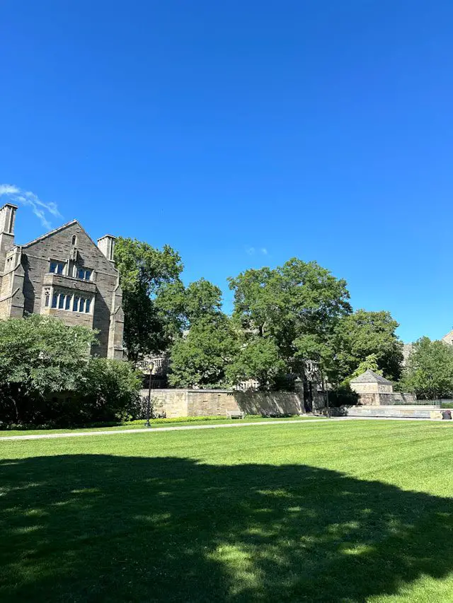 a large building sitting on top of a lush green field