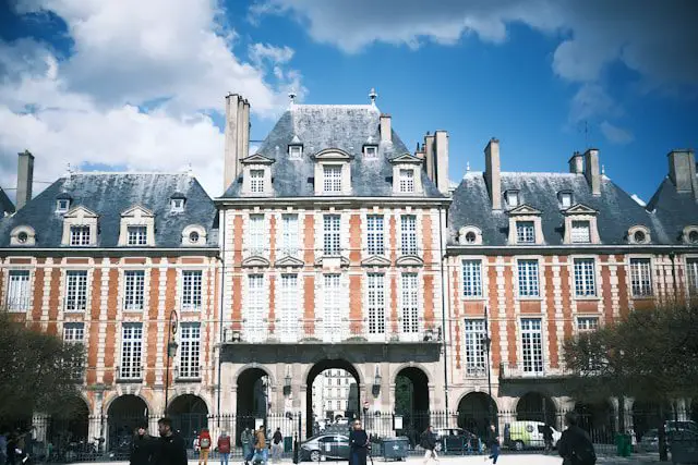 a large building with many windows and people walking around