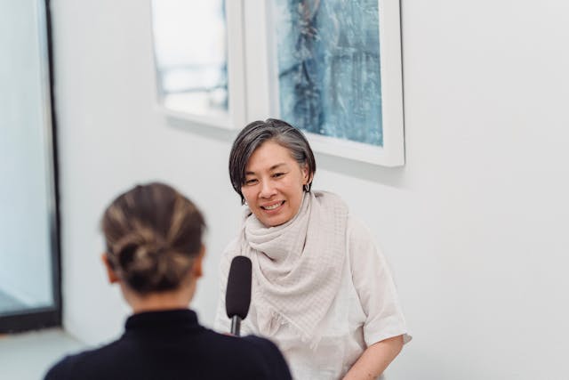 a woman being interviewed by a reporter