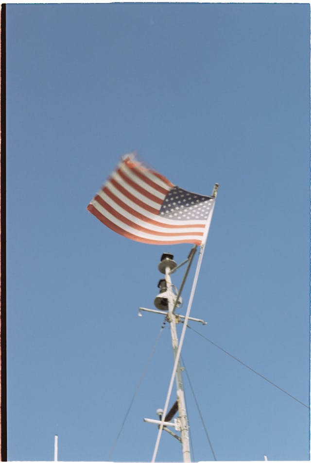 american flag waving against clear blue sky