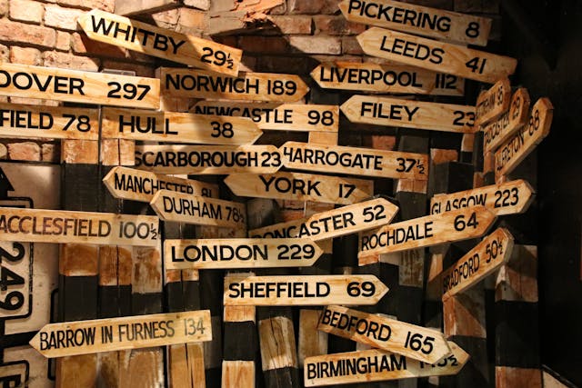 brown wooden signage hanging beside wall