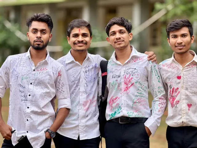 cheerful group of friends celebrating in white shirts