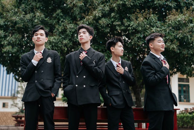 confident students in school uniform outdoors
