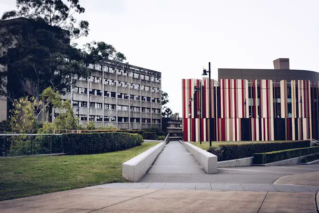 green grass field near brown concrete building during daytime