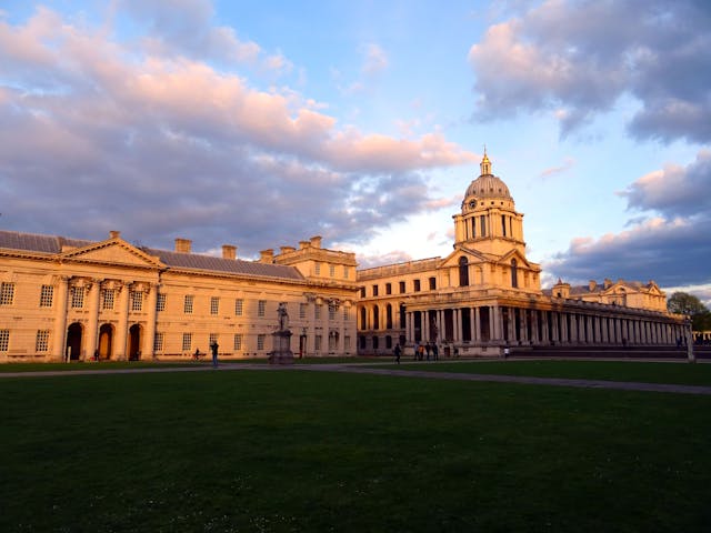 green grass in front of building