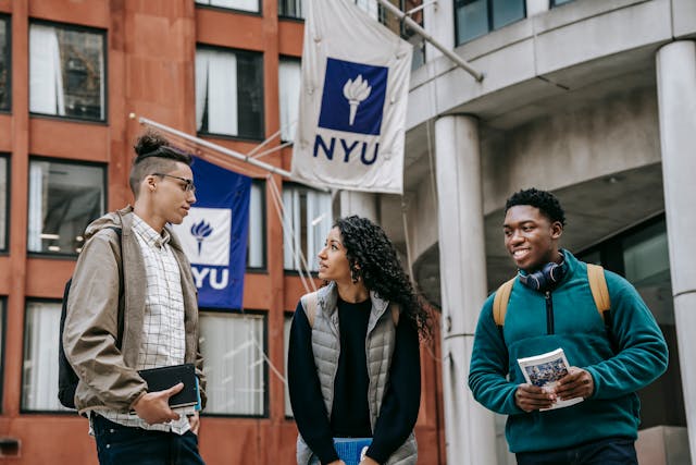 multiethnic students standing near university together