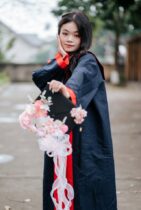 young graduate celebrating outdoors with flowers