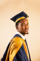 young graduate in cap and gown portrait