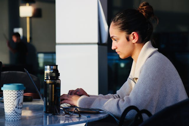 young woman working on laptop at cafe in brossard