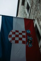 a flag hanging from the side of a building