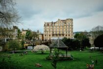 a green park with a building in the background
