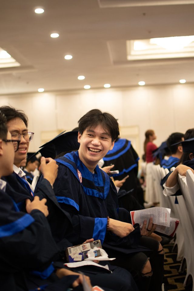 a group of young men sitting next to each other