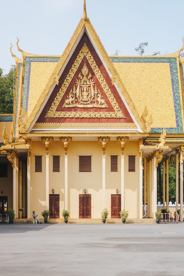 a large building with a yellow roof and red doors