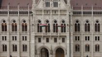 a large white building with two flags on top of it