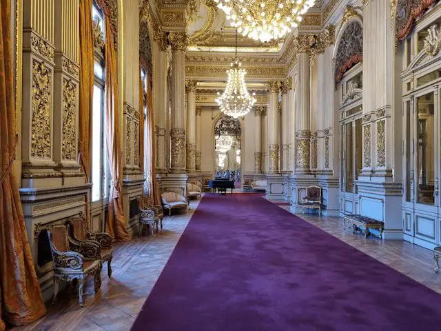 a room with a purple carpet and a chandelier