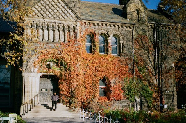 an old building with ivy growing on the side of it