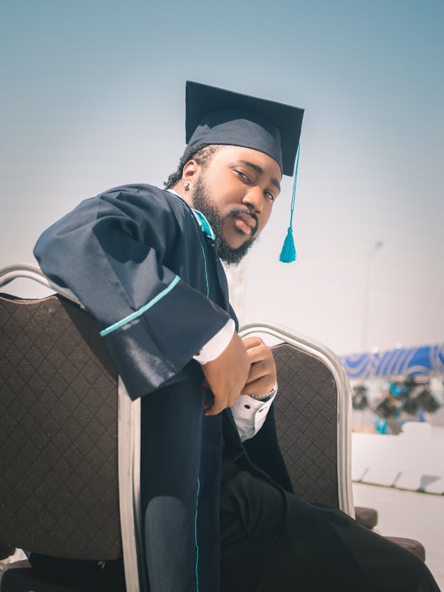 confident college graduate at outdoor ceremony