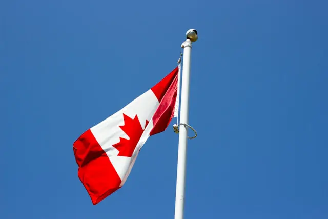 flag of canada under blue sky at daytime