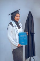 graduation portrait of young woman in academic gown