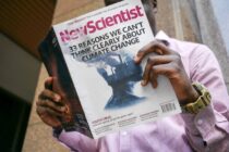 man reading new scientist book