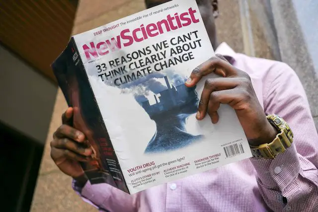 man reading new scientist book